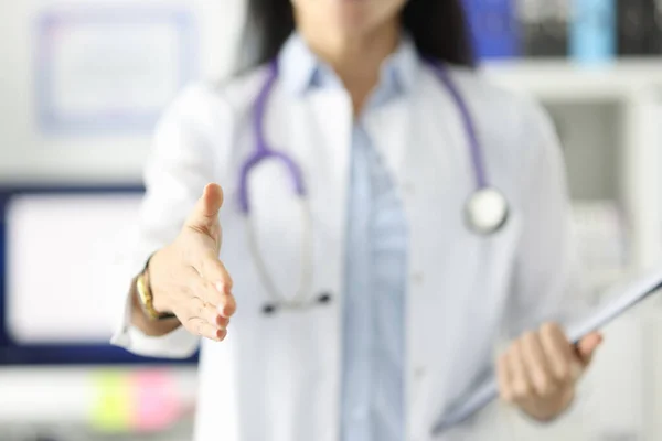 Woman doctor stretching out her hand for handshake closeup — Stock Photo, Image