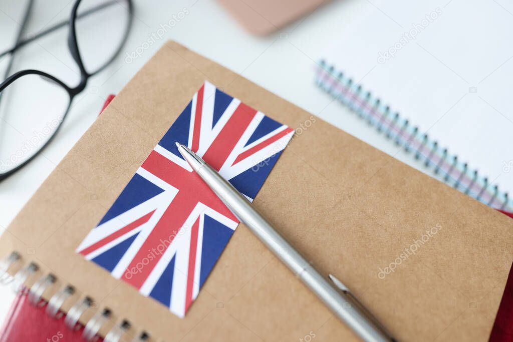 On table is diary with British flag and pen