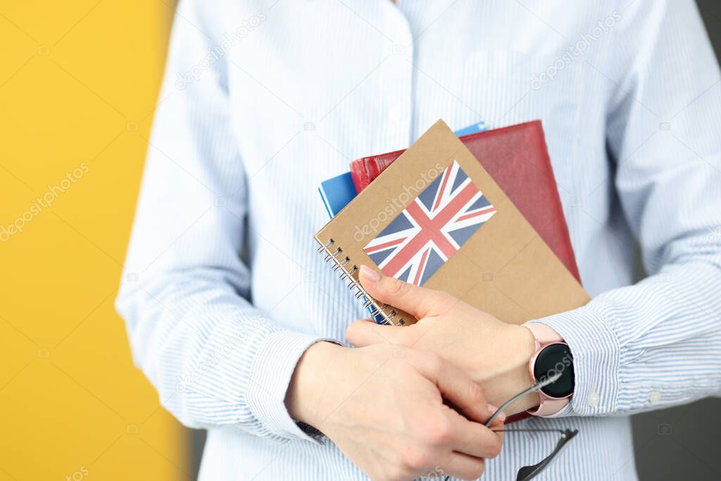 Female silhouette holding diaries with British flag