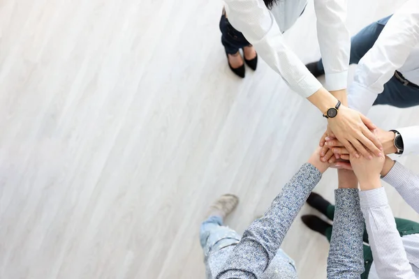 Partners stand and hold their hands in single gesture