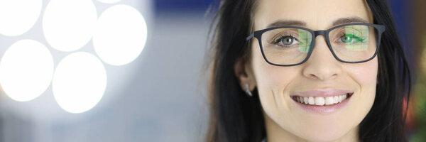 Portrait of smiling doctor with glasses in operating room.