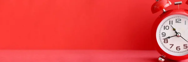 Red alarm clock on red background closeup — Stock Photo, Image