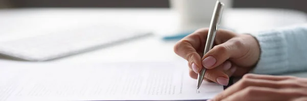 Woman writing with ballpoint pen in documents at table at home closeup — Stock Photo, Image