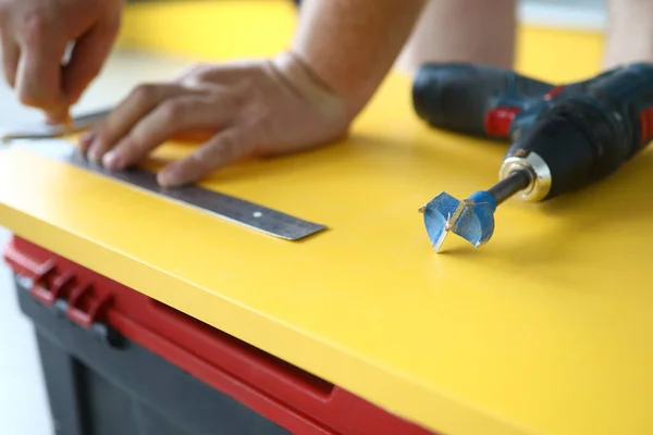 Zbliżenie wiertarki z dyszą i metalowym linijką układającą się na żółtej drewnianej powierzchni — Zdjęcie stockowe