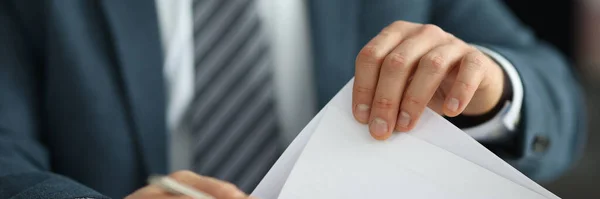 Businessman in suit holding documents in his hands in office closeup — Stock Photo, Image