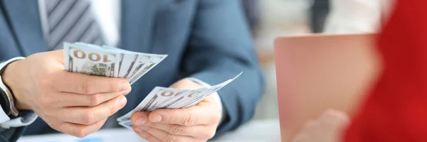 Businessmen counting cash dollar bills in office closeup