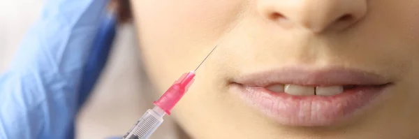Beautician gives woman an injection in face