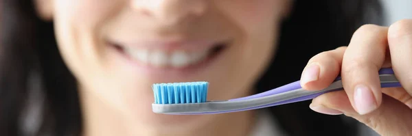 Woman holding toothbrush in her hands closeup — Stock Photo, Image