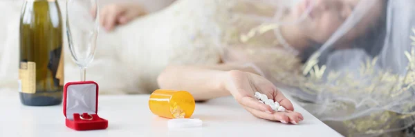 Bride lying on couch with handful of pills in her hand closeup — Stok fotoğraf