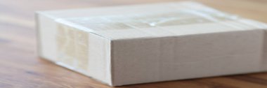 Cardboard packing box is on table closeup
