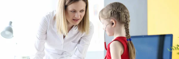 Pediatrician doctor together with little girl play medicine with toy — Stock Fotó