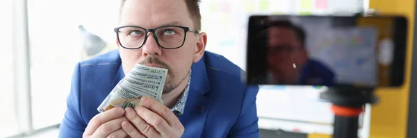 Addicted businessman sniffs smell of money closeup — Stockfoto