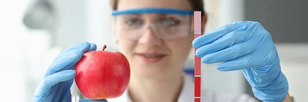 Doktorn håller i rött äpple och remsa med mått — Stockfoto
