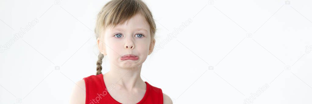 Portrait of little offended girl on white background