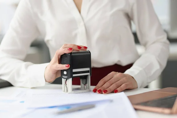 Businesswoman puts stamp on credit documents at work desk —  Fotos de Stock