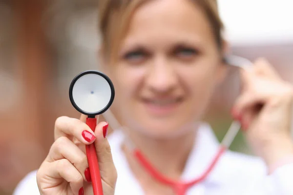 Mosolygó női orvos kezében orvosi sztetoszkóp közelkép — Stock Fotó