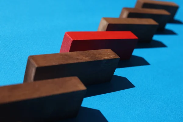Step to success in business model with one red wooden block in shape of ladder closeup