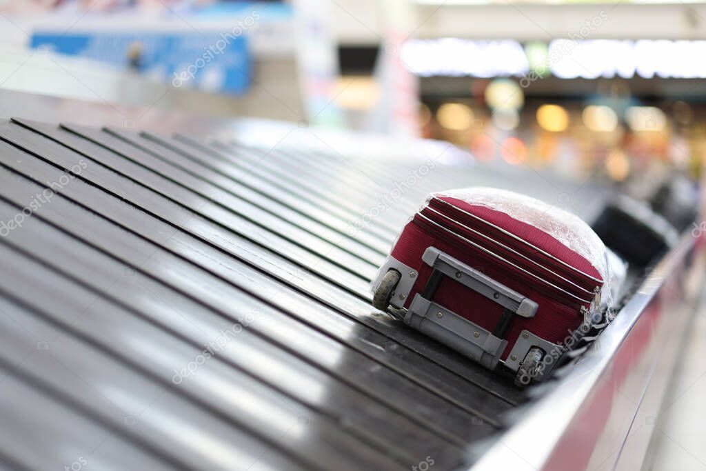 Empty airport and luggage on tape closeup