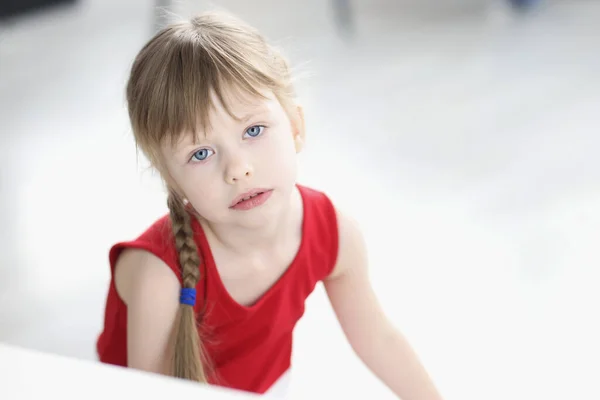 Portrait of sad little girl in red dress — Stock Photo, Image