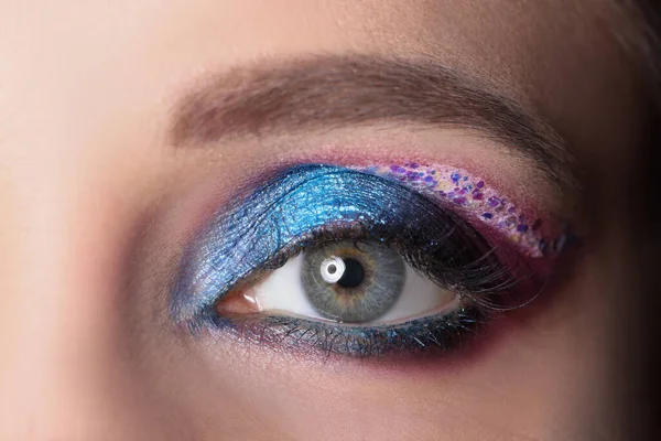 Closeup of female eye with bright shiny purple shadows — Stock Photo, Image