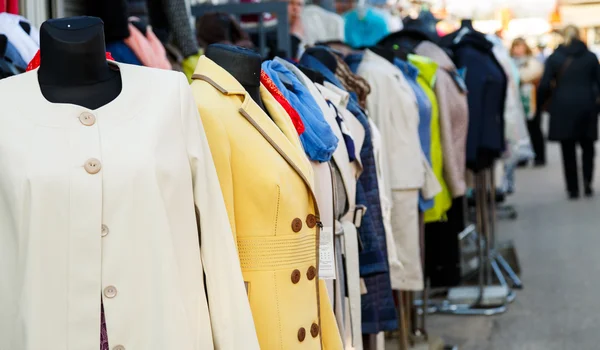 Row of mannequins with different coloured women's clothes on mar — Stock Photo, Image