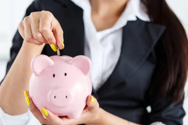 Piggy bank and woman — Stock Photo, Image