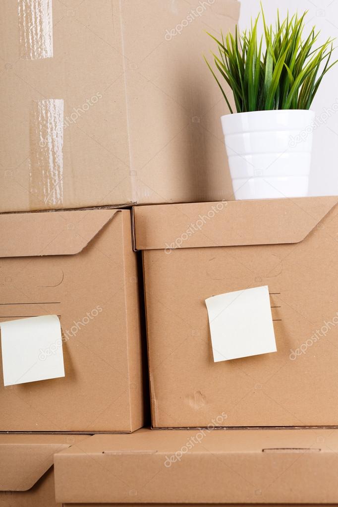 Pile of brown cardboard boxes with house or office goods