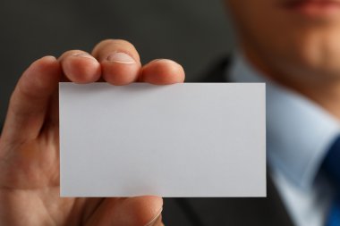 Businessman in suit and hand holding blank calling card