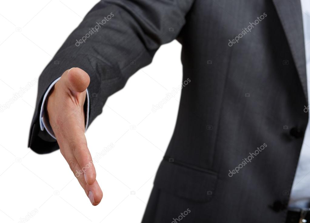 Businessman in suit and tie offering hand to shake