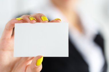 Businesswoman in suit hand holding blank calling card