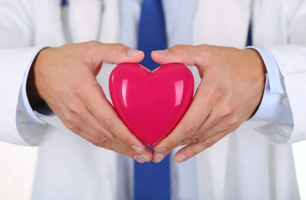 Male medicine doctor hands holding red toy heart — Stock Photo, Image