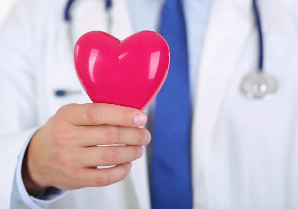 Male medicine doctor hands holding red toy heart — Stock Photo, Image