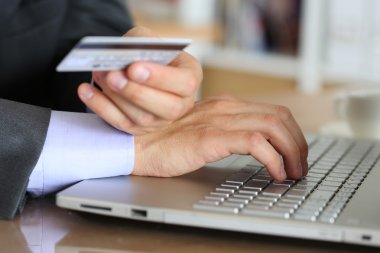 Hands of businessman in suit holding credit card