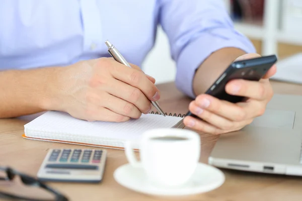 Male hand holding silver pen