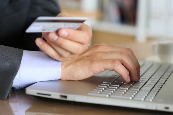 Hands of businessman in suit holding credit card — Stok fotoğraf