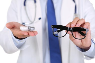 Male doctor hands giving pair of black glasses clipart