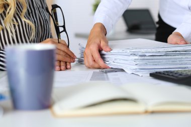 Hands of two women in office
