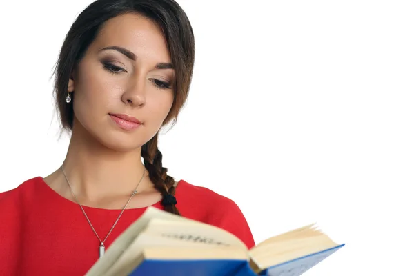 Beautiful woman in red dress wearing plait reading blue book — 스톡 사진
