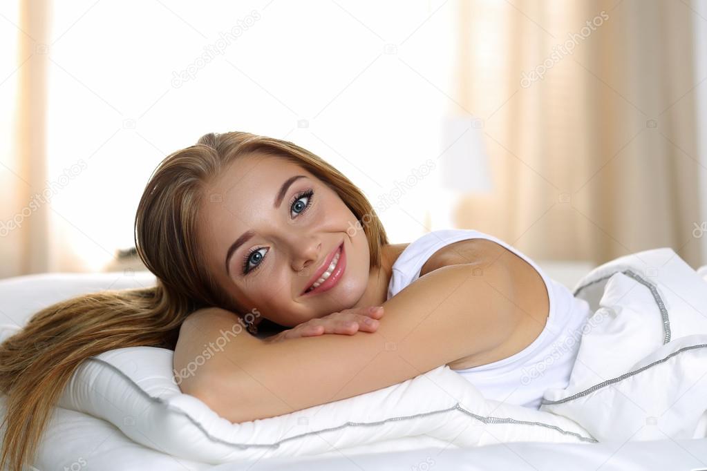 Young beautiful blonde smiling woman portrait wake up early morn