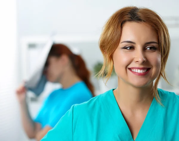 Beautiful female medicine doctor laughing on her colleague — 图库照片