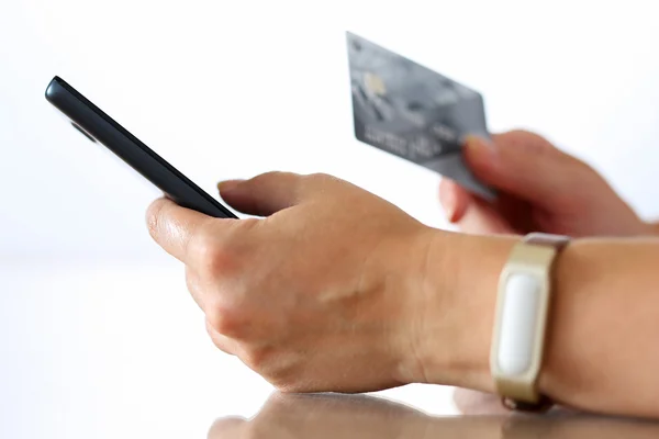 Female hands holding credit card and making online purchase usin — Zdjęcie stockowe
