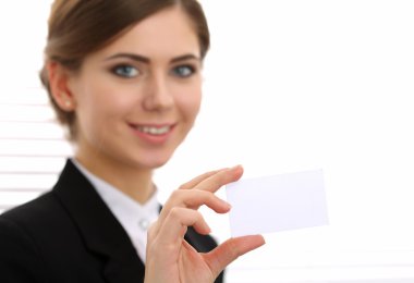 Businesswoman in suit hand holding blank calling card