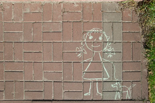 child drawing on sidewalk tile