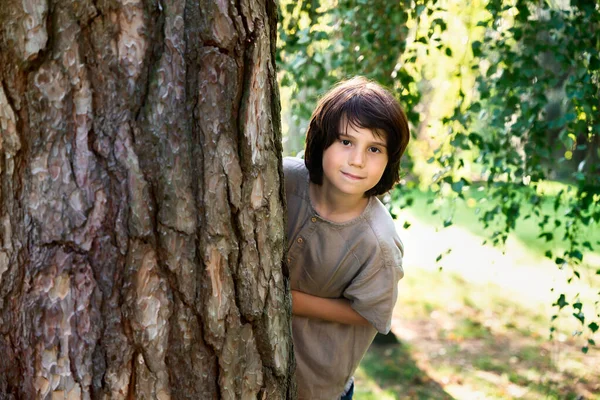 Νεαρό Αγόρι Δέκα Ετών Κρύβεται Πίσω Από Ένα Μεγάλο Δέντρο — Φωτογραφία Αρχείου