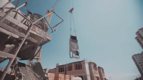 Контейнер с бетоном, движущимся вниз со строительным краном — стоковое видео