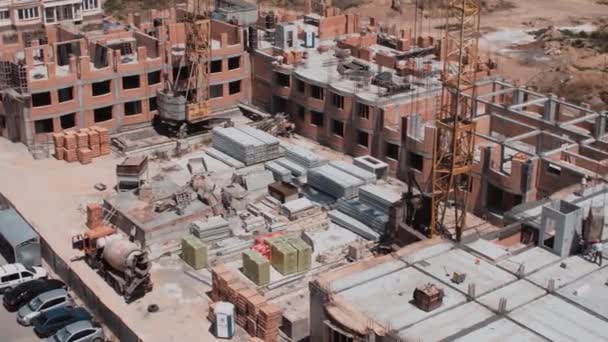 Vista aérea sobre un sitio de construcción del edificio de ladrillos rojos — Vídeo de stock