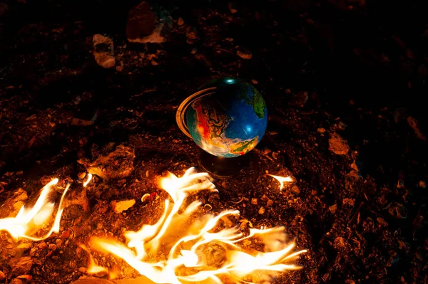Close up of globe in fire at the floor of abandoned building