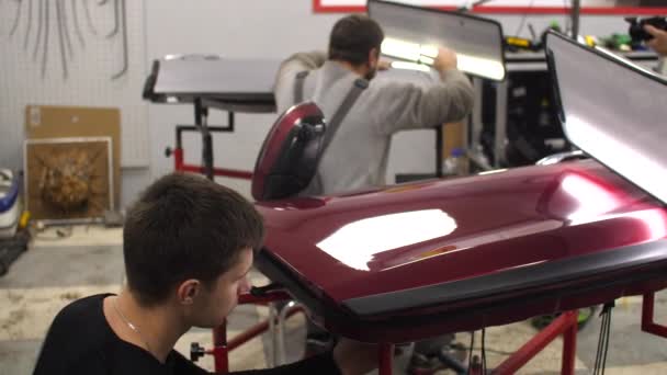 Pair of car repair workers using innovative PDR technology qualification repair — Video