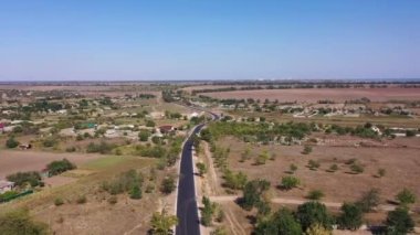A flight through fresh road above cozy village in sunny day