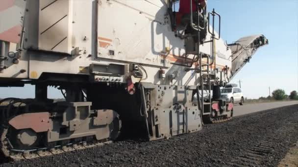 Slow moving of asphalt paver trough a road in sunny day — 비디오